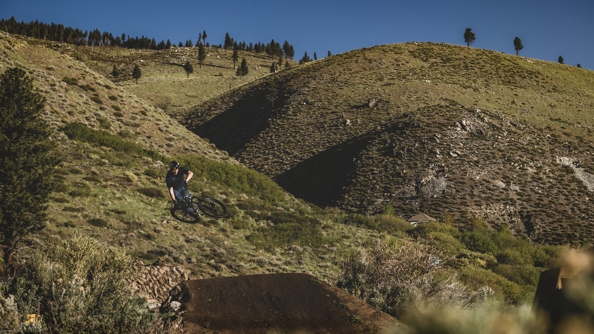 Greg’s backyard jump lines nestle up to the surrounding mountainside. Photo: Ryan Cleek